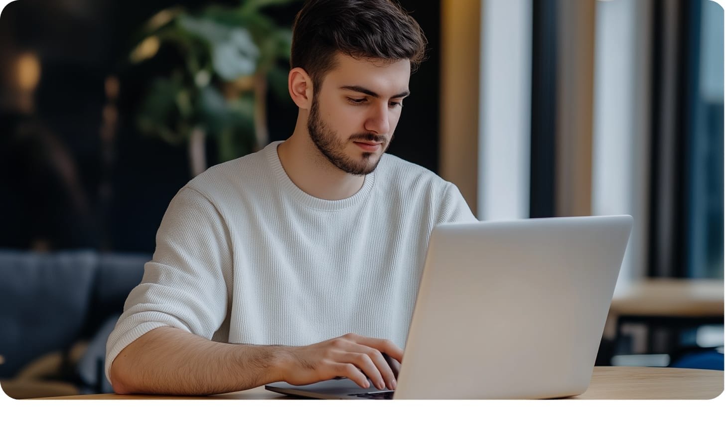 Professional developer working on a laptop for insurance IT consulting.